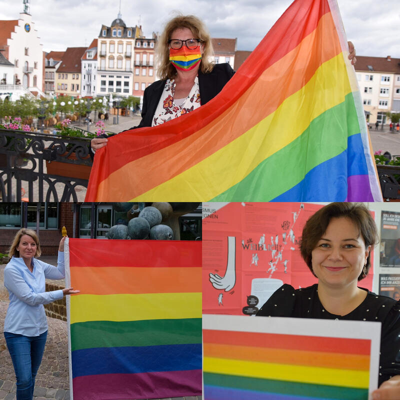 Regenbogenfahne als Zeichen f&uuml;r mehr Toleranz: Die Gleichstellungsbeauftragten der Stadt Landau Evi Julier (oben), des Landkreis S&Uuml;W, Isabelle St&auml;hle (links), sowie Germersheim, Lisa-Marie Trog (rechts), begehen den IDAHOBIT. 
